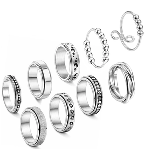 Set of 9 stainless steel spinner rings with matte finish and celestial patterns