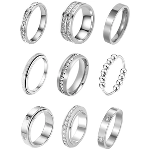 9-piece silver titanium steel ring set with matte and zircon pave designs on white background