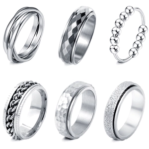Collection of six rotating stainless steel fidget rings in silver finish on white background