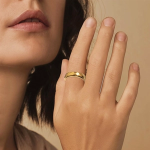 Elegant gold titanium spinner ring with geometric diamond-cut texture on a model's hand