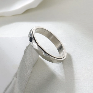 Minimalist 4mm titanium steel rotating ring with geometric diamond cut surface for stress relief
