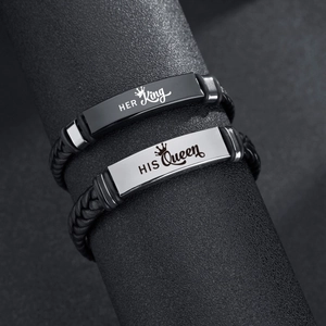 Detail of leather bracelets with Her King and His Queen engraved stainless steel plates