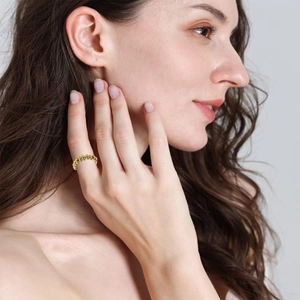 Nahaufnahme eines goldenen drehbaren Angstperlenrings am Finger zur Entspannung