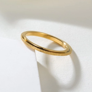 Golden matte finish titanium steel spinning ring with polished inner band on stone