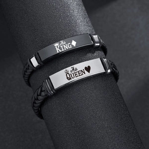 Detail of woven leather couple bracelets with His King and Her Queen steel plaques