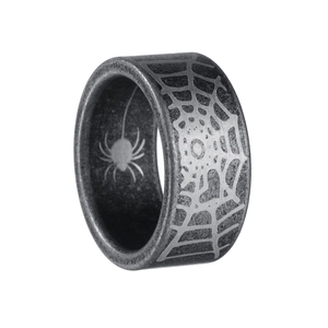 Macro detail of gothic spider web engraving on wide band vintage steel ring