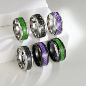 8mm black titanium rings with colorful carbon fiber inlays on white geometric steps