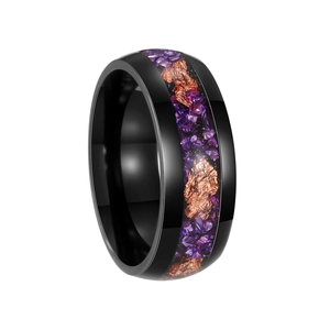 Macro view of black titanium ring featuring purple amethyst inlay and gold foil detail