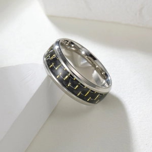 8mm black titanium ring with blue carbon fiber inlay and gold square accents