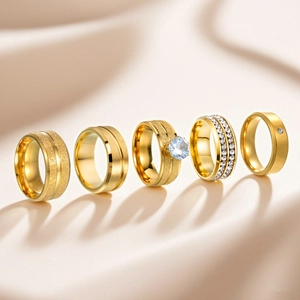Collection of matte and polished gold stainless steel rings with minimalist cubic zirconia
