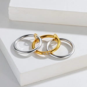 Three linked minimalist titanium steel rings with gold accent and diamond inlay on stone