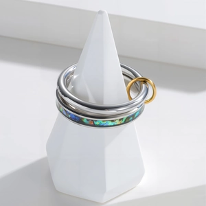 Modern layered stainless steel ring set with iridescent inlay and gold accent circle