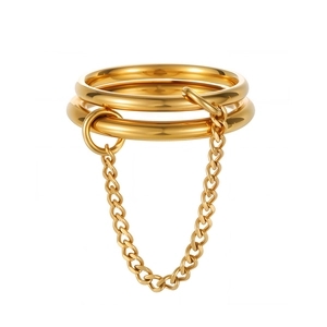 Detailed close-up of a triple-ring gold set featuring a hanging chain connection detail