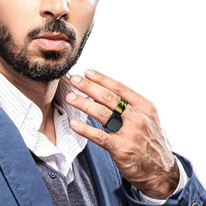 Detail of men's black stainless steel ring with gold stripe and star pattern on finger