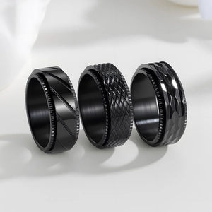 Set of three 8mm black stainless steel rotating rings with mesh and stripe textures