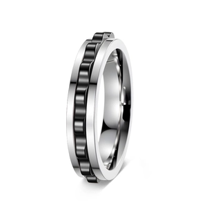 Close-up of a 6mm rotating fidget ring with silver steel and black gear wave detail