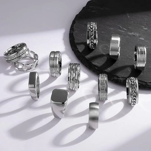 Detailed collection of silver titanium steel rings with chain texture and geometric patterns