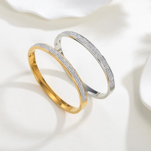 Polished titanium steel bangle set with pavé cubic zirconia in gold and silver finish