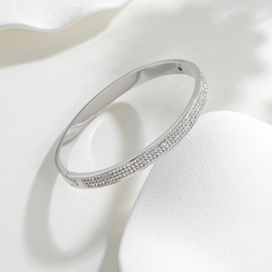 Polished titanium steel oval bracelet with micro-pave crystals on minimalist geometric stand