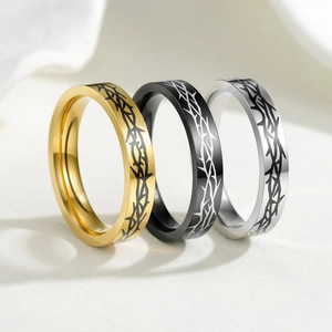 Set of three 4mm stainless steel rings in gold, silver, and black with thorn engravings