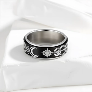 Spinner ring with black celestial sun moon pattern on silver brushed stainless steel band
