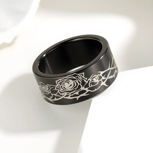 Black brushed stainless steel wide band ring featuring silver rose and thorn patterns