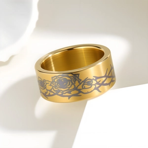 10MM golden stainless steel ring featuring thorns and rose pattern on white stand