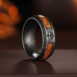 Macro shot of Viking Tree of Life ring with Norse runes and yellow wood inlay
