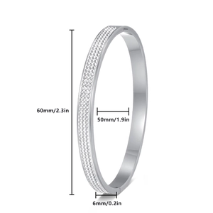 Silver oval stainless steel bangle with three rows of pavé crystals in 45-degree view