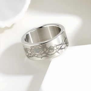 Macro detail of gothic rose and thorn engraving on wide 10mm stainless steel ring
