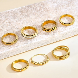 Set of 7 gold-toned 304 stainless steel rings with stars and moon engravings and cubic zirconia