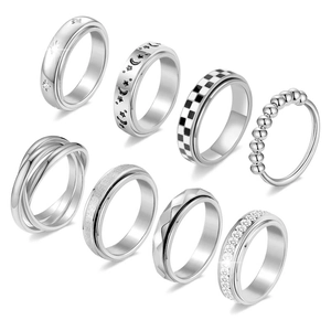 8-piece set of silver stainless steel spinner rings with moon, star, and crystal designs
