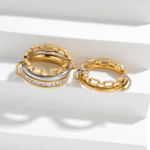 Modern layered chain ring in mixed gold and silver tones with pavé crystal accents