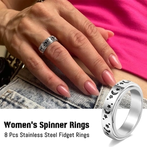 Close-up of 8pcs women's stainless steel spinner rings featuring star and moon engravings