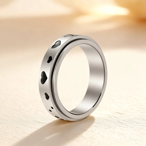 Polished silver spinner ring made of stainless steel with black heart patterns