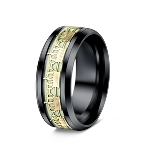 Detailed macro view of a luminous crown ring with black and gold stainless steel finish