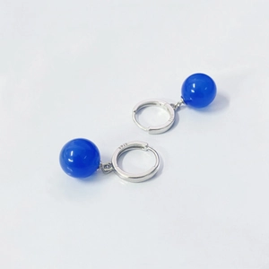 Detail view of S925 sterling silver stamp on blue agate bead dangle earrings for women