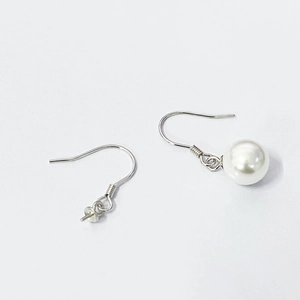 Macro detail of S925 sterling silver ear hooks with a lustrous white pearl for DIY jewelry