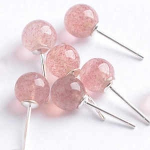 Macro shot of 6-8mm pink strawberry quartz stud earrings with silver pins on white background
