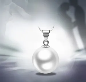 Macro detail of round black pearl pendant with S925 sterling silver chain and clasp