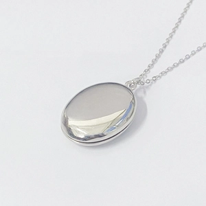 Polished S925 sterling silver oval locket necklace with a glossy mirror finish on white background
