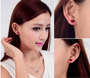 Detail view of 925 sterling silver stud earrings with natural red agate gemstone beads