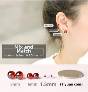 Macro detail of red zircon round studs in 1.5mm to 8mm sizes with S925 silver posts