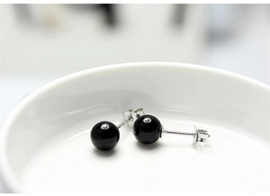 Detailed view of S925 sterling silver stamp on minimalist black onyx stud earrings