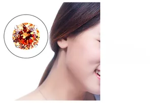 Macro detail of silver four-claw stud earring with round orange zircon on model