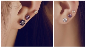 Detail of s925 silver four-prong stud earrings with colorful cubic zirconia on ears