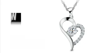 Detail of 925 sterling silver heart pendant with white zircon in platinum plating