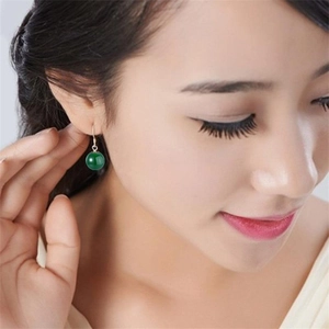Detailed close-up of green jade chalcedony drop earrings with elegant silver hooks