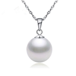 Macro shot of a high-luster round white pearl pendant with an elegant silver wave chain