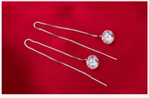 Macro shot of 925 sterling silver long tassel earrings with sparkling cubic zirconia gems
